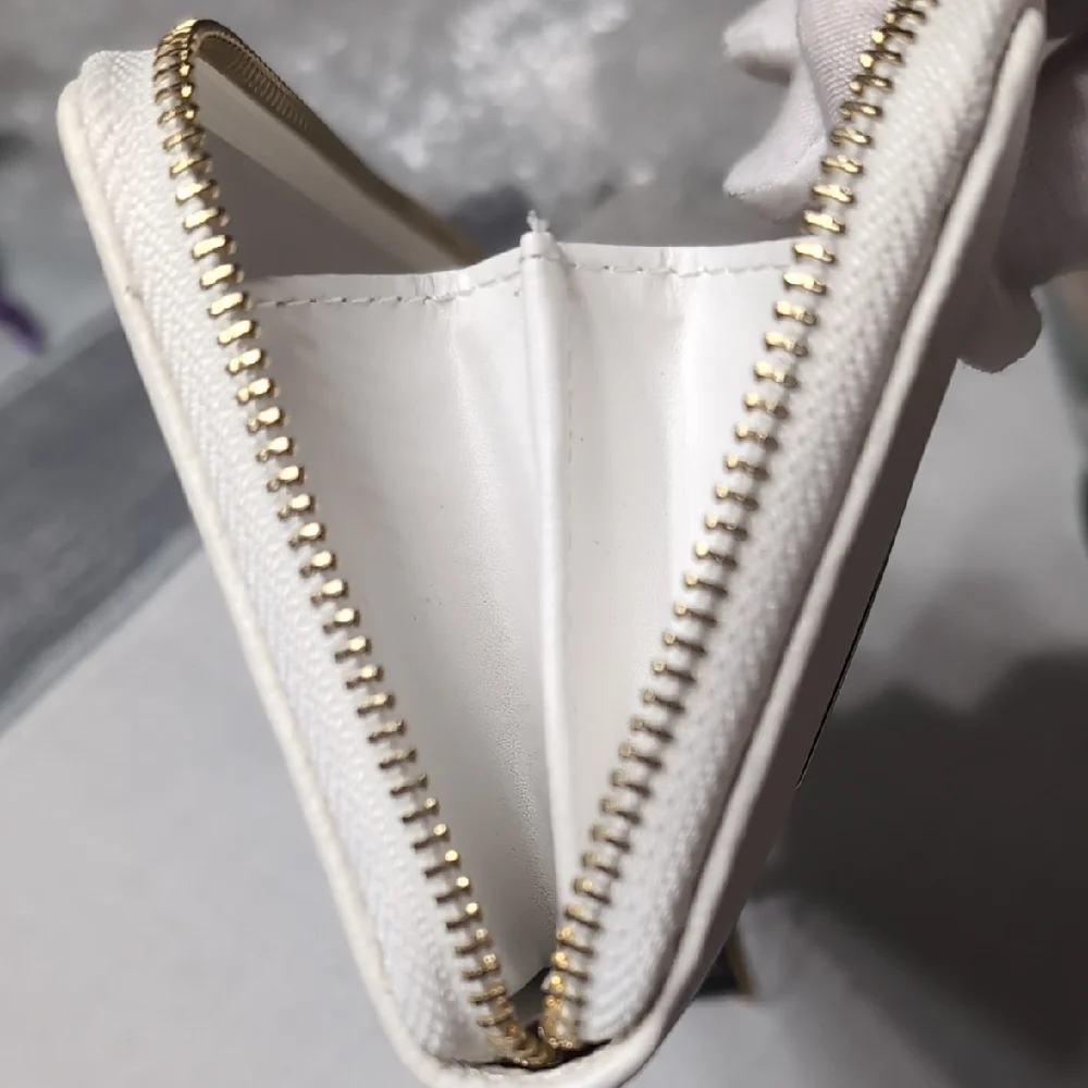 bebe White Zip Wristlet Clutch with Gold Logo